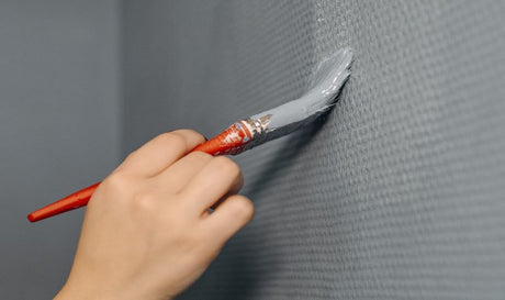 A Person Painting a Wall.