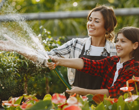 Mom and Daughter Watering the Plants Together