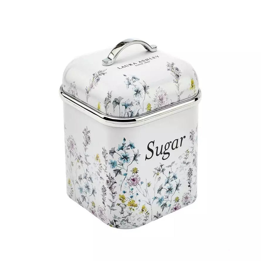 A square metal sugar canister with a hinged lid and top handle, decorated with a delicate multicolor floral pattern on a white background. The word 'Sugar' is printed in black script on the front, and 'LAIR & LEYMENT' is visible near the top of the lid.