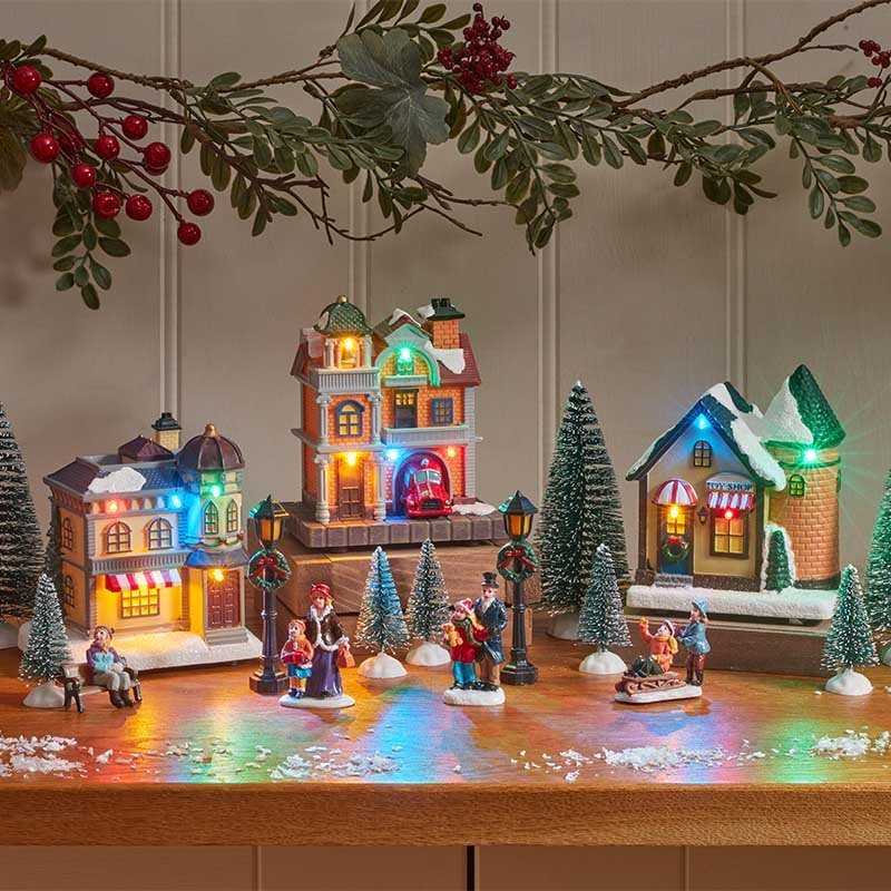 Christmas Avenue Musical Moving SnowScene Village – 17 Piece Set - XMAS CERAMIC WOOD RESIN GLASS ORNAMENTS - Beattys of Loughrea